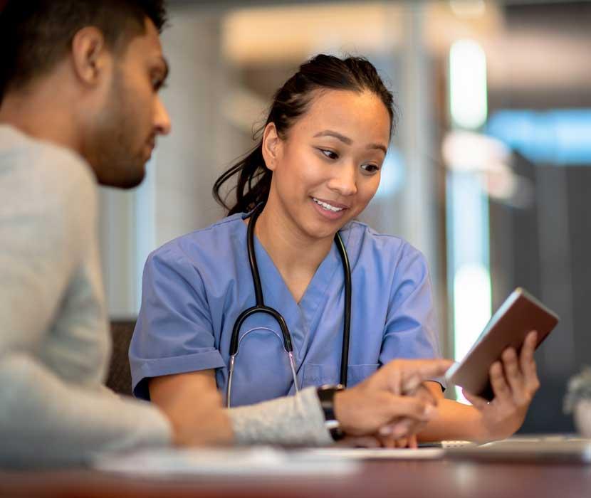 Nurse helping a patient with a tablet