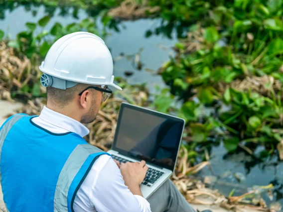 Bio engineer working with plantlife in an urban waterway