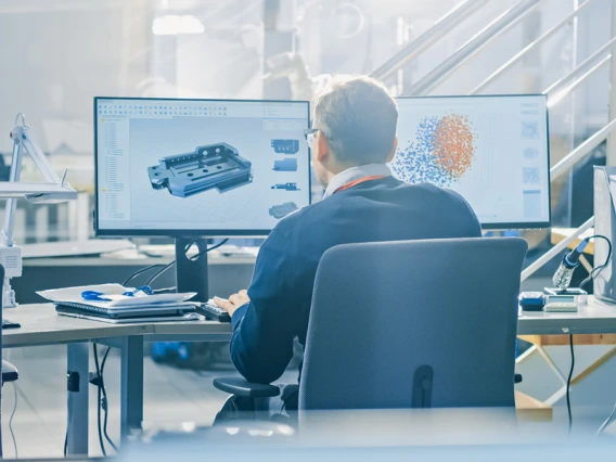 Engineer developing machine parts with CAD programming