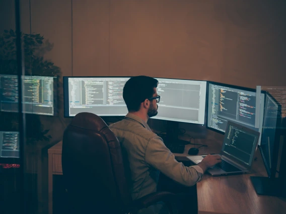 Software engineer inspecting lines of code